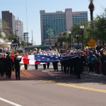 Military bearing Huge USA flag on Jacksonville Veteran's Day parade 2013