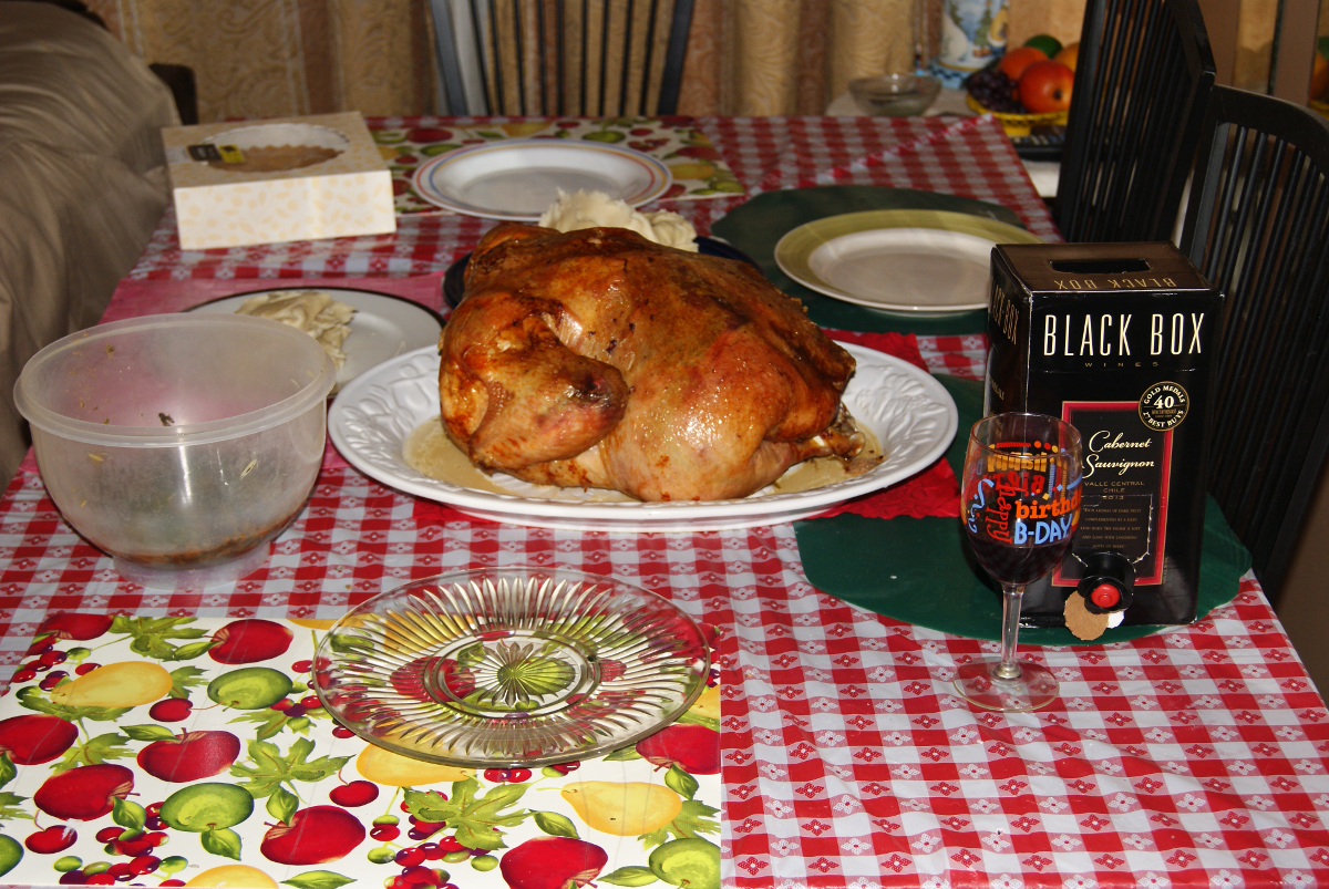 Thanksgiving 2014 dinner with the turkey, collard green, fufu, cherry pie, and a Black Box of Cabernet Sauvignon wine.